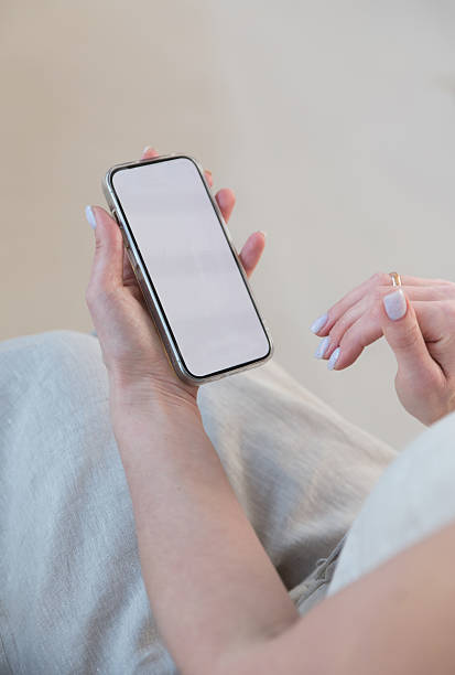istock white screen of mobile phone in female hands 2206547342
