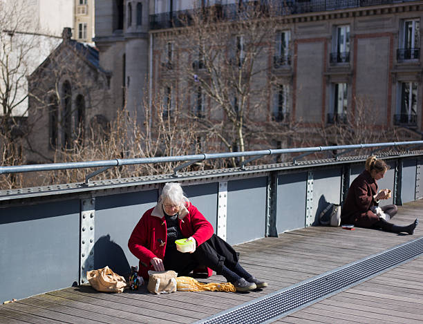 Paris, France: Women eating lunch on La Coulee Verte René-Dumont, a green space built on a former railway viaduct. It’s in the 12th arrondissement.