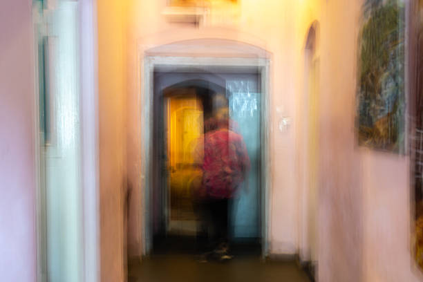 Conceptual background interior abstract impressionist unrecognisable person walking down a colourful hallway in retro colours.