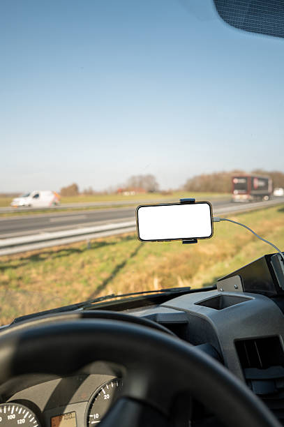 istock Smartphone with blank screen showing gps navigation app in car on highway 2206552109