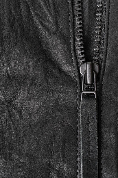 istock Crumpled black suede textured vertical background with black metal zip 2206552309