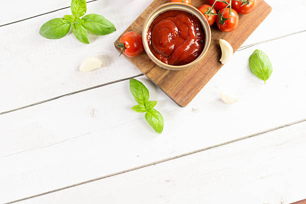 istock Tomato paste, sauce, ketchup and cherry tomatoes on branches and basil 2206553187