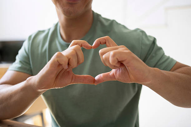 istock Man making heart shape with hands, showing love and affection 2206553359