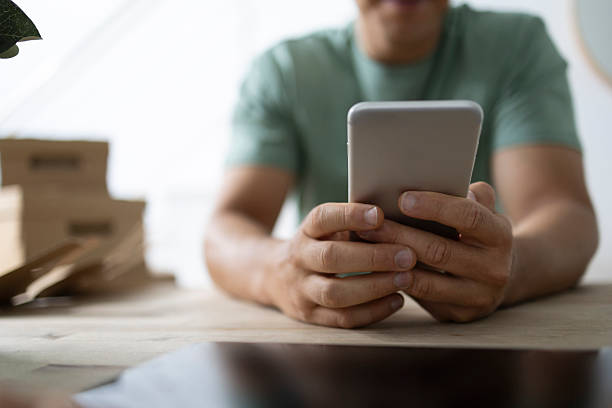 istock Small business owner using smartphone to manage online orders 2206553420