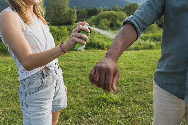 istock Young couple spraying tick repellent 2206556554