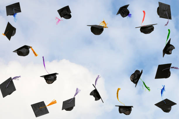istock Graduation caps thrown in the sky 2206558996