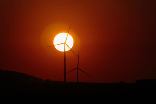 Wind Turbines And Sun At Sunset - Renewable green electric Energy