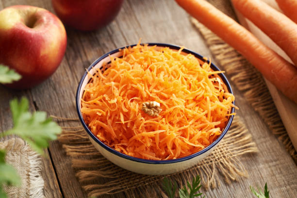 istock Fresh carrot salad in a bowl with red apples 2206562522