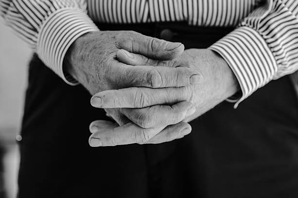 istock The old man's hands are folded into a lock 2206563223