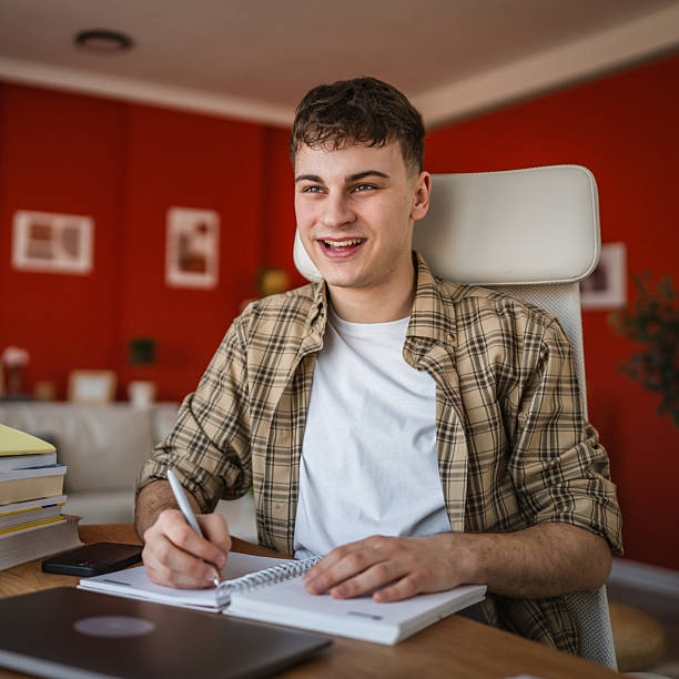 istock young man student learn and prepare exam from notebook and laptop 2206564017
