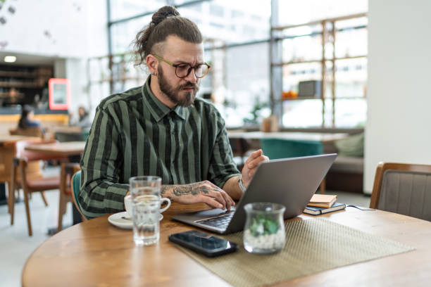 istock Young handsome Caucasian businessman working at cafe 2206567770