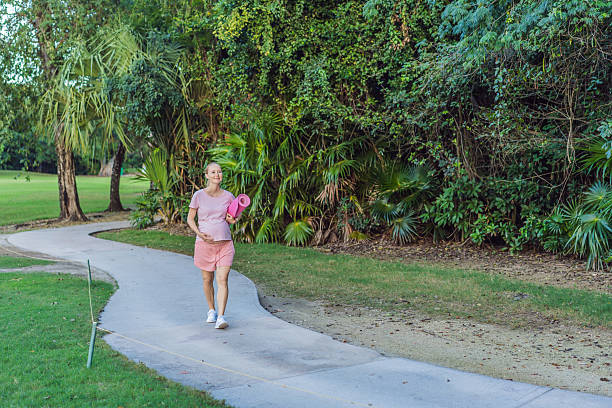 istock Energetic pregnant woman takes her workout outdoors, using an exercise mat for a refreshing and health-conscious outdoor exercise session 2206571756