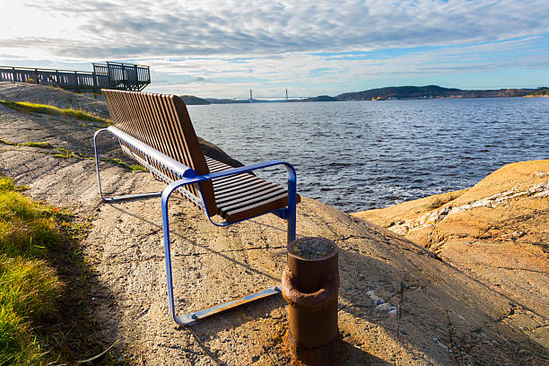 Europe, Sweden, Uddevalla. Uddevalla Bridge, cable-stayed bridge crossing Sunninge sound. Bench at viewpoint.