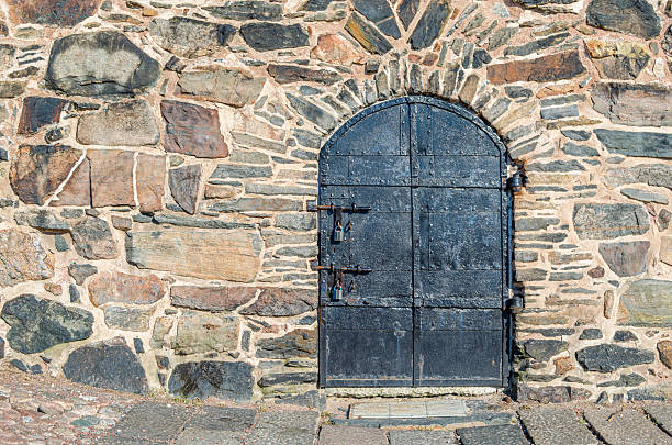 Old wooden door surrounded by plants in castle combe, a charming village in england
