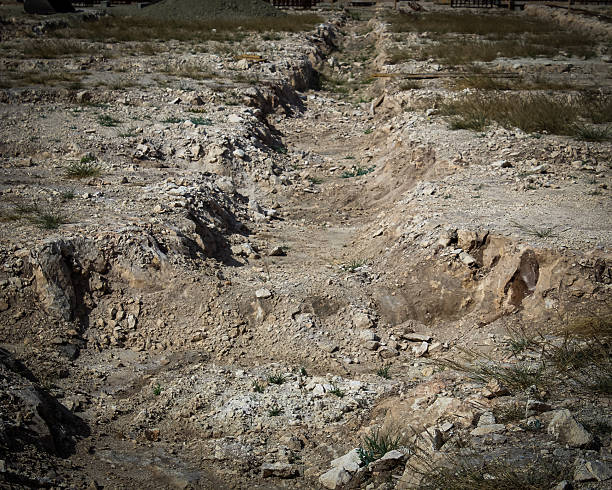 istock concept of extreme terrain or rough journey ahead. excavated construction site. rocky path tunneled or dug out. conquering adversity. 2206576025