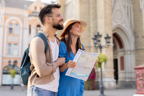 Couple joyfully wandering through a city's historical square area.