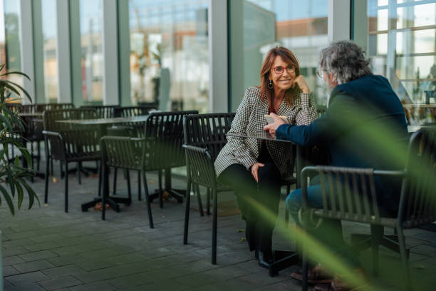 istock Business partners enjoying a coffee break at a modern cafe 2206578154
