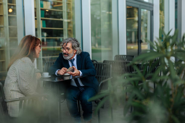 istock Business partners discussing during a coffee break outside the office 2206578157