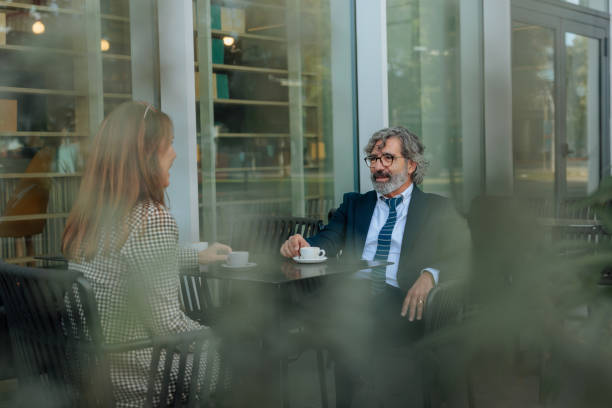 istock Business partners enjoying a coffee break together outside a cafe 2206578188
