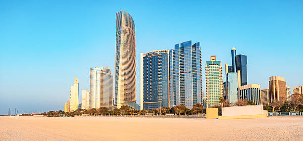 istock Panoramic view of modern skyscrapers towering over the sandy Corniche beach in Abu Dhabi, UAE, highlighting urban and natural beauty 2206578338