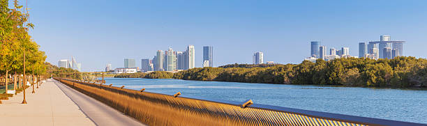 istock Scenic panoramic view of mangrove park walkway with modern Abu Dhabi skyline, featuring lush greenery and serene waterway 2206578350