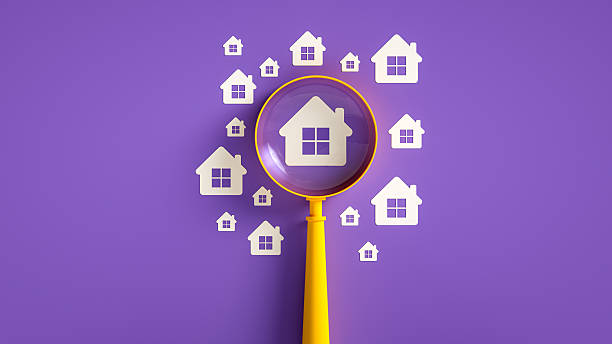 A 3D render illustrating the concept of searching for a home or real estate. A yellow magnifying glass is positioned over a central white house icon, with smaller house icons scattered on a vibrant purple background. This visual symbolizes the process of house hunting, property searching, or real estate market analysis. Ideal for real estate agencies, mortgage brokers, or content related to finding the perfect home. The clean design and contrasting colors create a clear and engaging illustration.