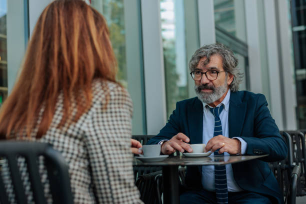 istock Business people having a meeting while drinking coffee at a bar table 2206585254