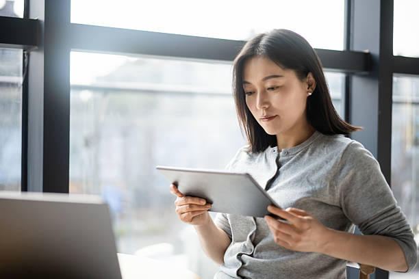 istock asian businesswoman working on digital tablet 2206586856