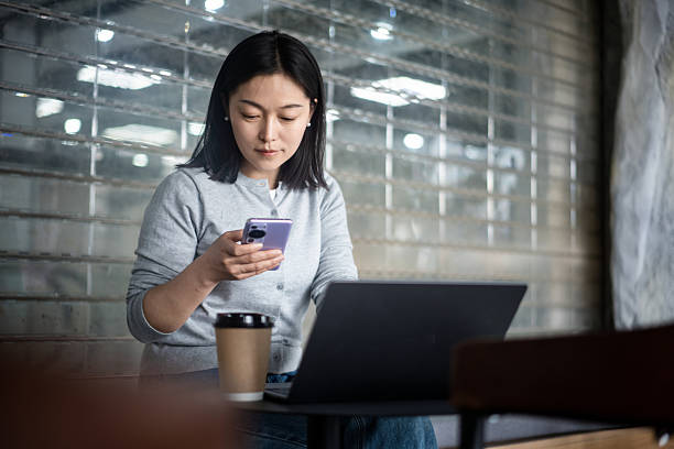 istock asian female using smart phone in coffee shop 2206587970