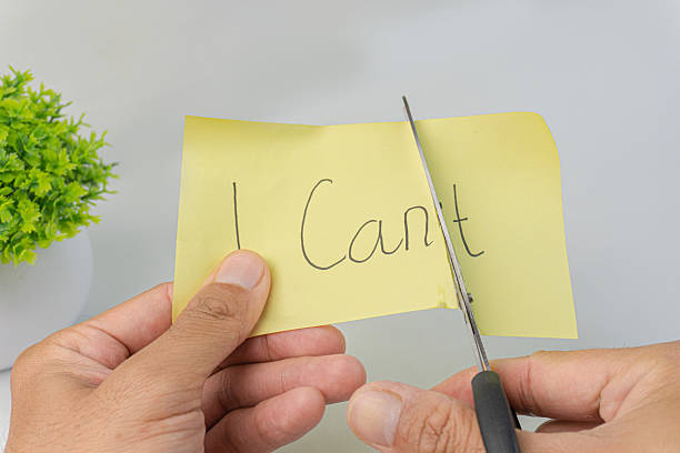 istock Hands holding scissors cutting I Can't written on a yellow sticky note with the plant. 2206588781
