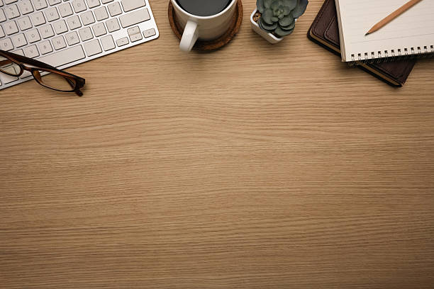 istock Minimal desk with wireless keyboard, a coffeecup, notebook, and succulent plant 2206595217