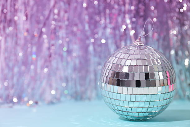 istock Disco ball with festive silver ribbons on blue background 2206595255