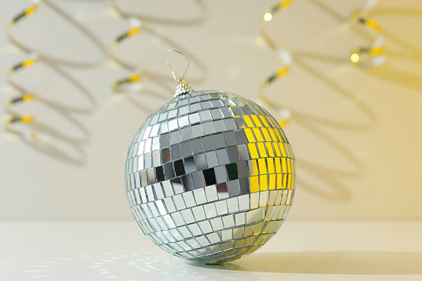 istock Disco ball with festive golden ribbons on background 2206595388