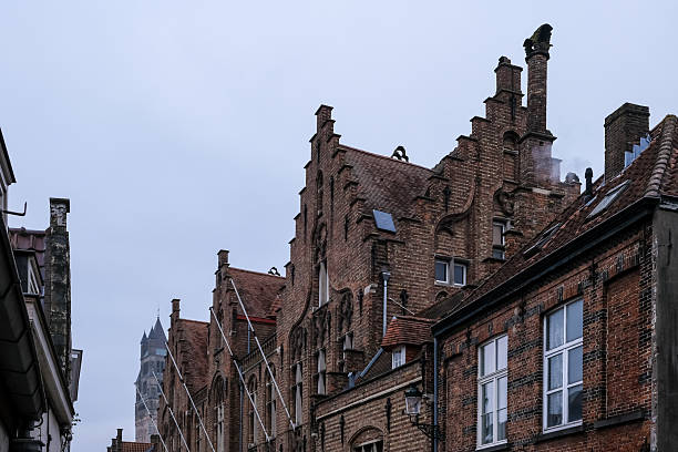 Bruges, Belgium – Typical facades of buildings adorned with stone reliefs and stepped gables, characteristic of Flemish architecture.