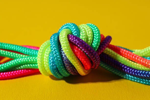 istock A knot of multi-colored laces on a yellow background 2206596668