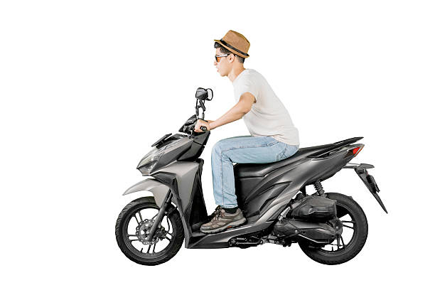 istock Young Man Riding a Black Scooter in Forward-Leaning Posture Wearing Hat and Sunglasses on White Background 2206601965
