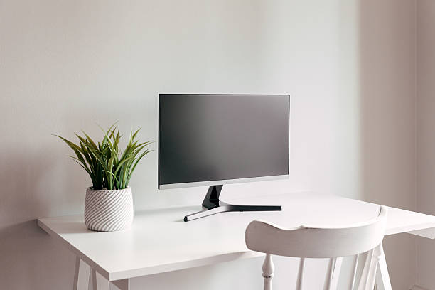 istock A black computer monitor on a white table. Mock up for design, teplate. Stylish minimalist interior. Gray background. 2206602098
