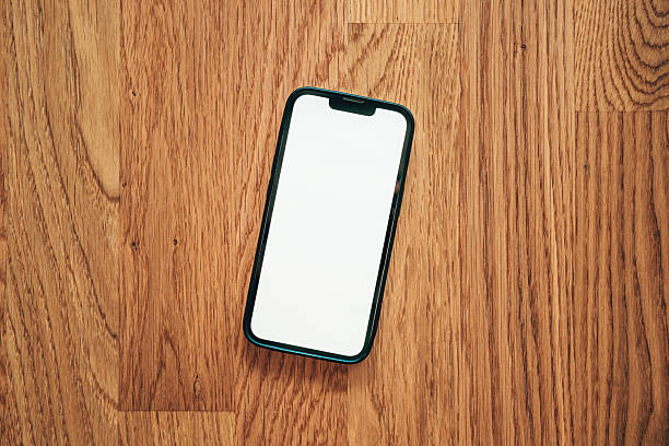istock Mobile phone blank white screen mockup. Smartphone on hardwood parquet flooring. 2206606084