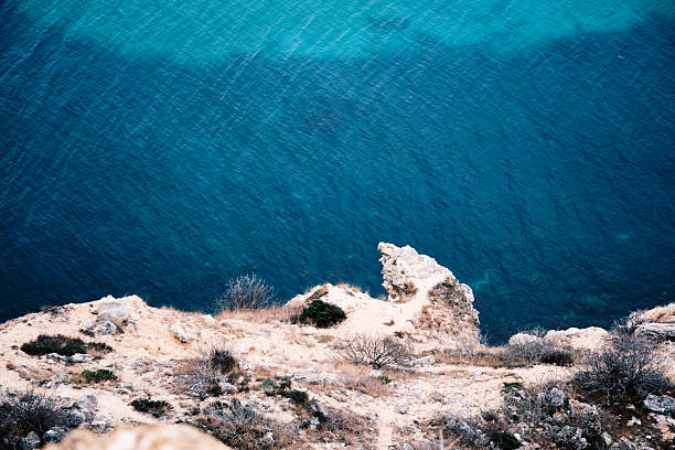 High angle view of sea bay surrounded by sandstone rocks