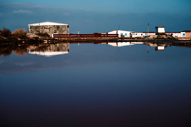 Pink salt-water lake with remains of salt farming