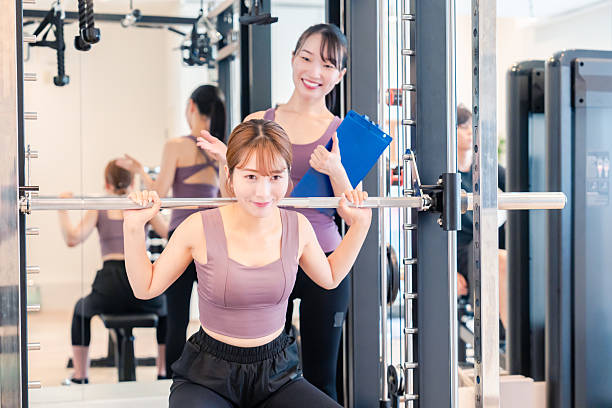 istock Woman undergoing personal training with a female coach at a gym 2206609905