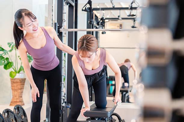 istock Woman undergoing personal training with a female coach at a gym 2206609906