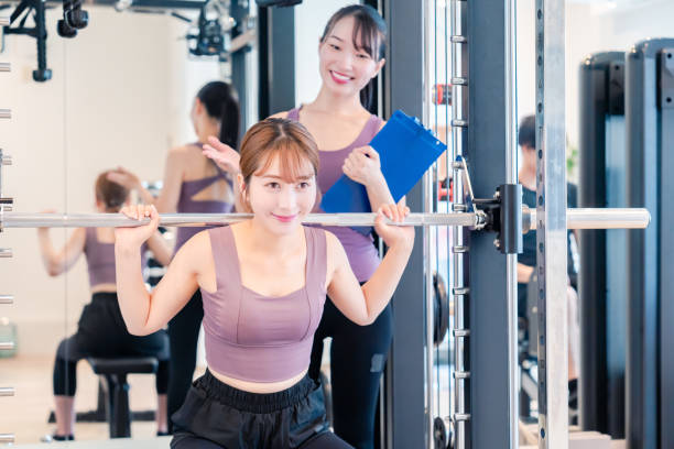 istock Woman undergoing personal training with a female coach at a gym 2206609908