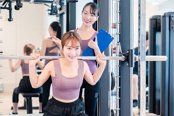 istock Woman undergoing personal training with a female coach at a gym 2206609909