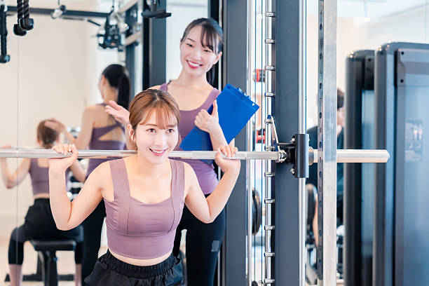 istock Woman undergoing personal training with a female coach at a gym 2206609911