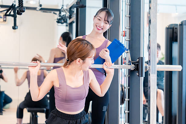 istock Woman undergoing personal training with a female coach at a gym 2206609915