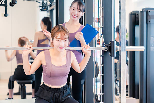 istock Woman undergoing personal training with a female coach at a gym 2206609918