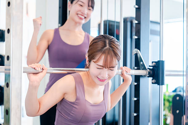 istock Woman undergoing personal training with a female coach at a gym 2206609919
