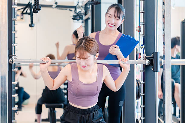 istock Woman undergoing personal training with a female coach at a gym 2206609921