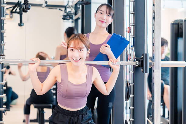istock Woman undergoing personal training with a female coach at a gym 2206609922